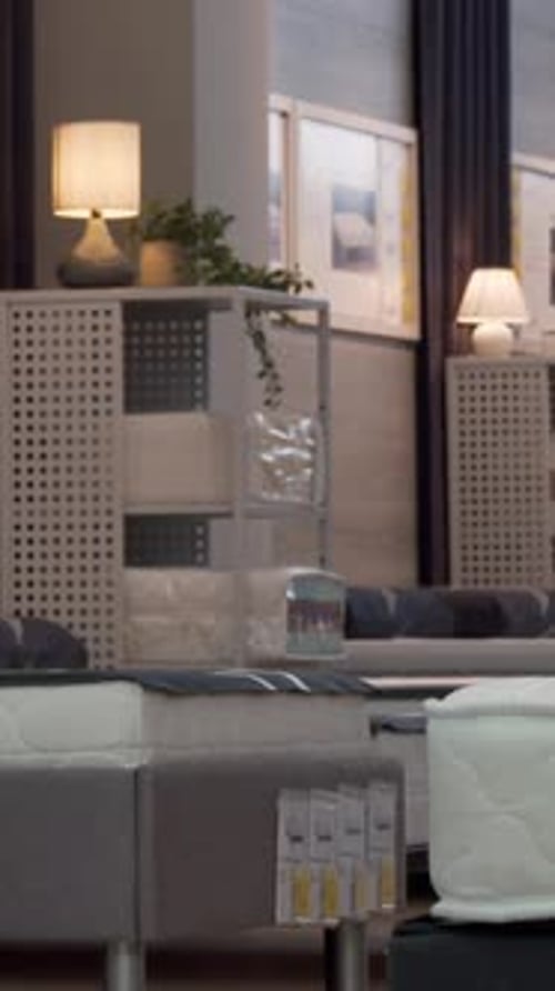Thoughtful Man Selecting the Perfect Orthopedic Mattress in a Stylish Furniture Store