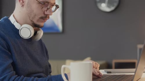 Office Worker in Wheelchair Using Laptop at Workplace