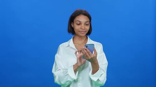 Woman Holding Up Smartphone with Green Screen Display