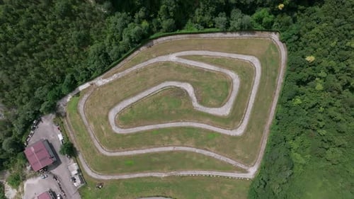 Aerial Footage of a Racetrack in Forested Area Ascent