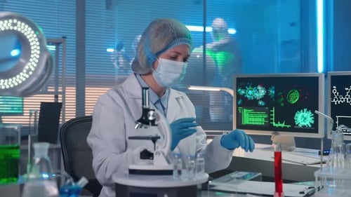 Scientist Works with Microscope in Modern Laboratory