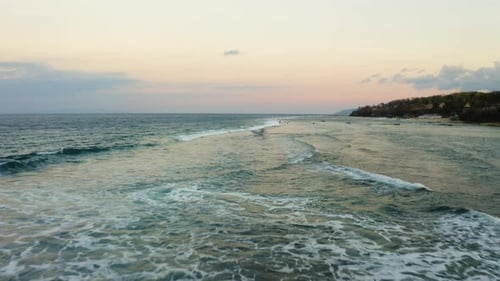 Low fly over hidden beach in Bali Indonesia. Exotic beach in Indian Ocean filmed in Nusa Penida trop