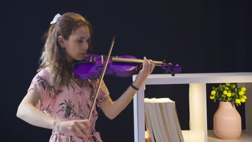 Woman Playing a Purple Violin