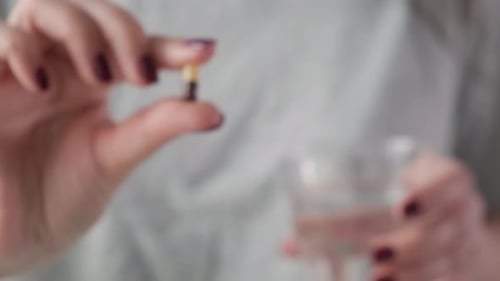 Adult Holds Capsule, Close-Up Medical Treatment