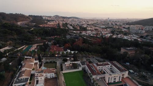 Slow aerial dolly overhead a luxury residential area with a central football field