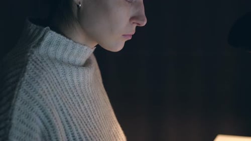 Portrait of a female working at the computer at night