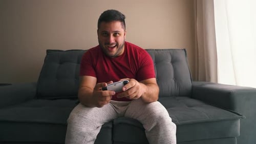 Young Adult Playing Video Games at Home