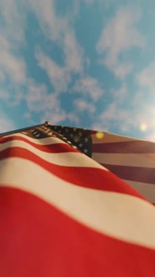 Waving American Flag Against Blue Sky Vertical Video