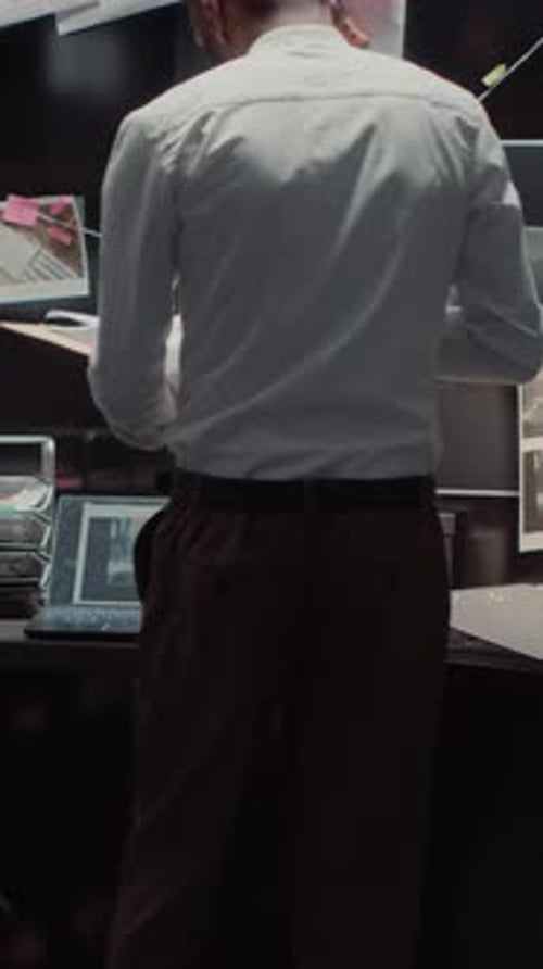 Man Connecting Clues on Crime Board