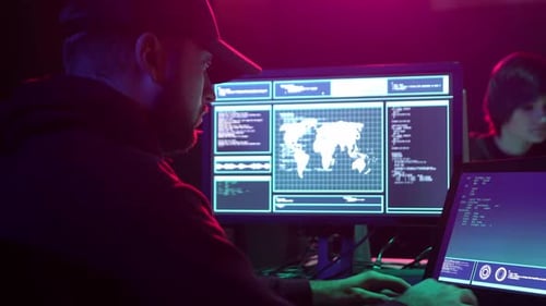Programmers Work at Night with Computer Screens Displaying Code