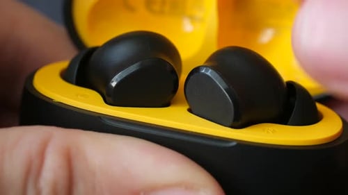 Man Hands Open Case Containing Wireless Headphones