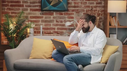 Adult Man Working on Laptop at Home