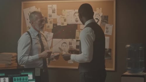 Team of Detectives Investigating Case Together at Night Office