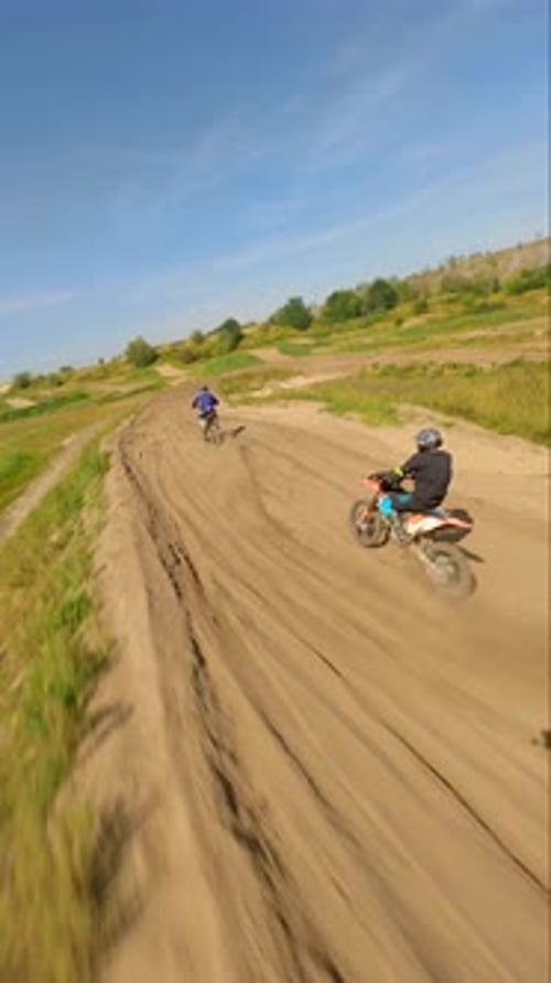Dirt Bikes Racing on Sandy Track in Countryside