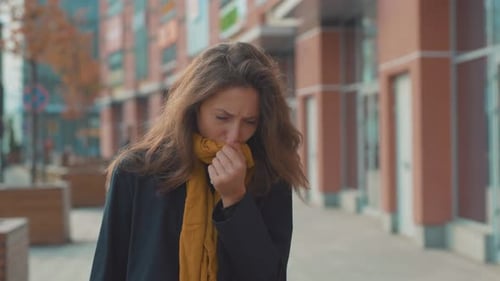 Close Up Young Woman Stand Look at Camera Coughs Feel Sick at Outdoor Fever Cold Allergy City