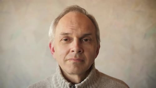 Adult Putting on Face Mask Indoors