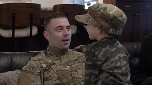 Soldier with Short Hair Talks to Young Child