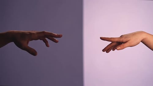 Man and Woman Touching Hands and Crossing Fingers Isolated on Purple Studio Background Close Up Shot