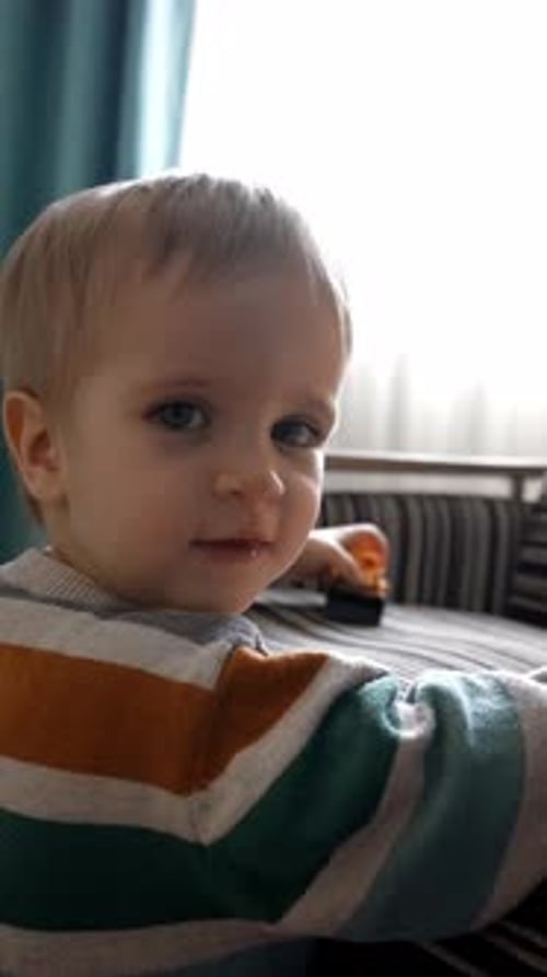 Child Plays with Toy Cars at Home