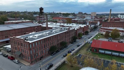 Aerial orbit shot of red brick warehouses and office buildings in small american town. Main street w