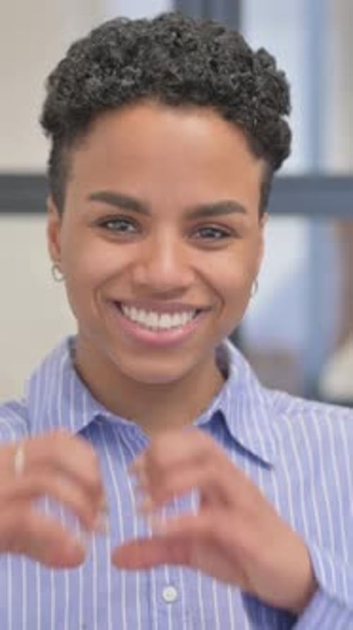 Smiling Woman Gesturing Heart Shape