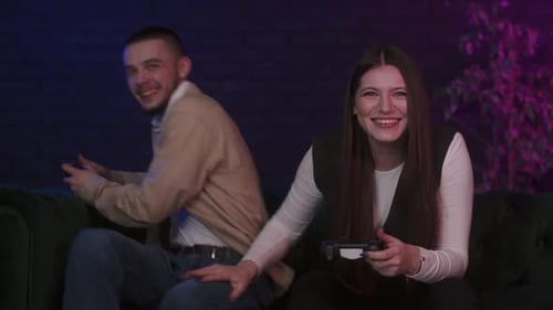 Couple Playing Video Games Together on Couch at Home