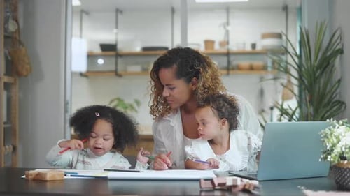 Woman Drawing with Two Young Children Indoors