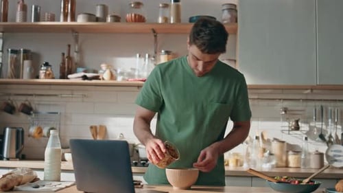 Young Adult Preparing Cereal in a Kitchen