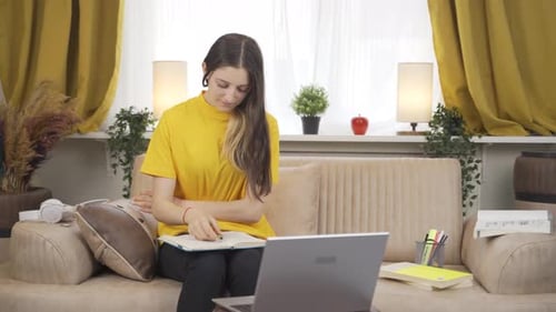 Woman studying with laptop in living room