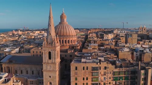 Aerial Pan of Valletta Malta at Sunset with Basilica Dome and Spire