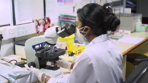 Medical Student Using A Microscope