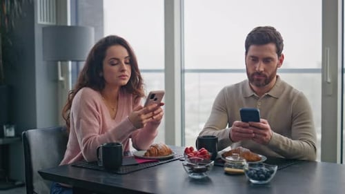 Couple at Breakfast with Phones