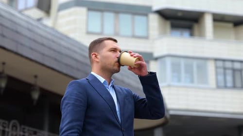 Man Enjoying Coffee in Urban Setting