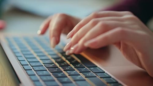 Woman's Hands Typing on a Laptop Keyboard Close-Up