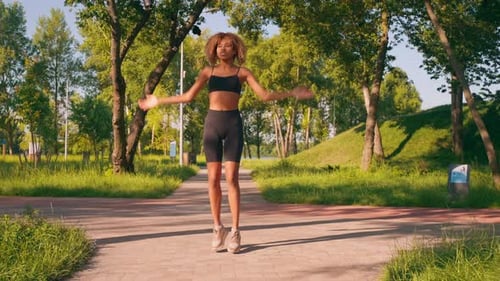 Workout Session in Sunny Park with Energetic Jumps and Exercises