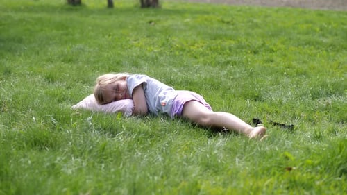 Jolie fille d'été allongée dans l'herbe verte