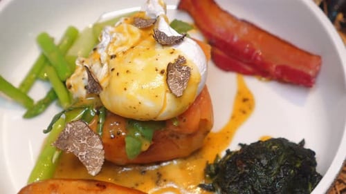 Plated Gourmet Eggs Benedict with Truffles and Bacon