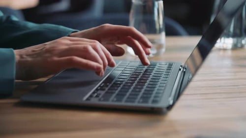 Woman in Formal Suit Working on Laptop While Sitting at Table in Cozy Restaurant Freelance Remote