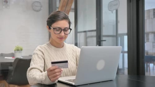 Online Shopping by Happy Indian Woman in Office