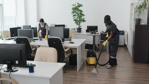 Man And Woman Cleaning Office