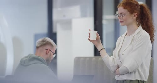 Young Woman Holding Cup in Modern Office