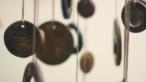 Artistic handmade clay wind chime hanging indoors