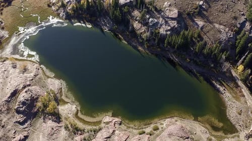 Aerial drone shot of Lake Blanche in Utah’s Big Cottonwood Canyon. Rising bird's eye view, revealing