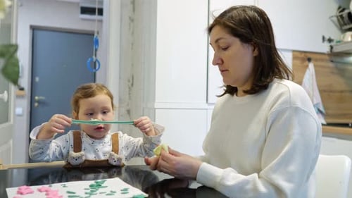 Woman and Child Playing with Modeling Clay at Home