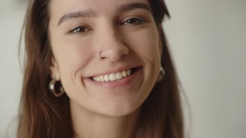 Close-up of Young Woman Smiling Happily Indoors