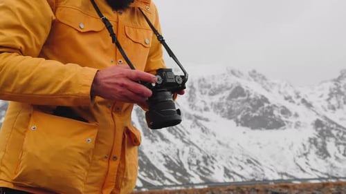 Landscape Photographer With DSLR Camera Looked At His Photographs. - close up, crop