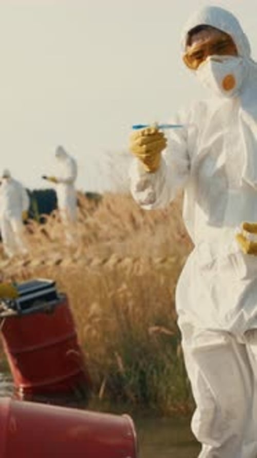 Scientists in Hazmat Suits Collecting Water Samples