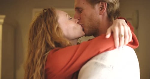 Loving Couple Embrace and Kiss Affectionately Indoors