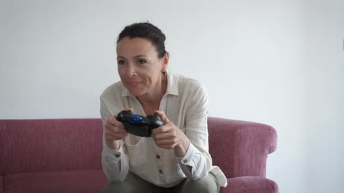 Eine ältere Frau spielt mit einem Joystick