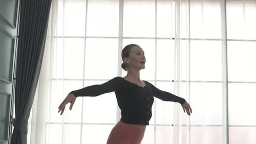 Friends practice ballet dance at studio.